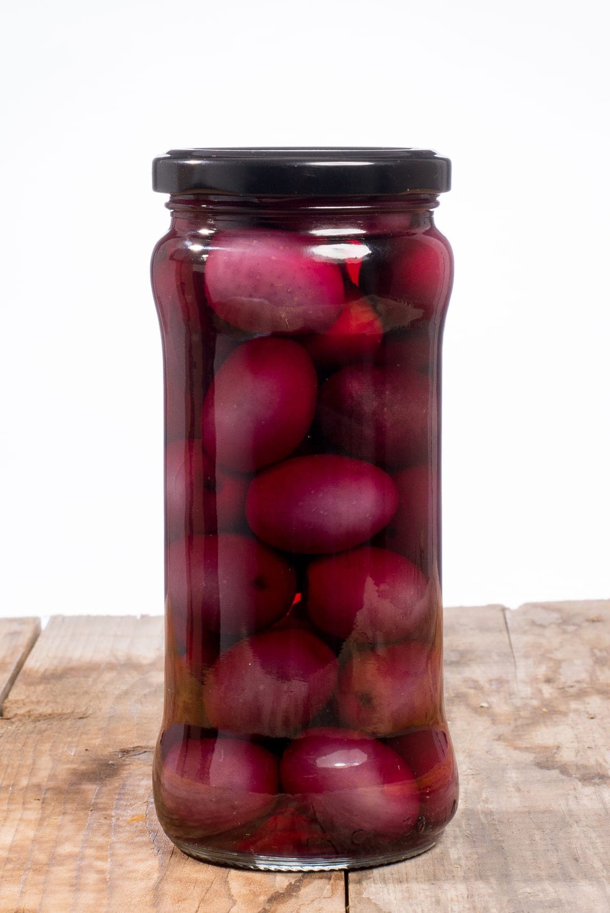 Jar of Guive black olives on a white background